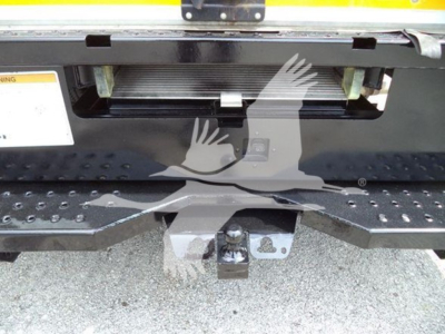 Ford E-350 cutaway rear view showing hitch and bumper step with tailgate opening and hydraulic lines visible.
