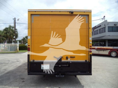 Ford E350 Cutaway rear view showing yellow body with white bird graphic decal and back doors.