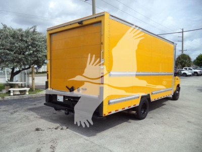 Ford E-350 cargo truck with bright yellow box body and logo of white birds on sides, rear view showing cargo doors and bumper.