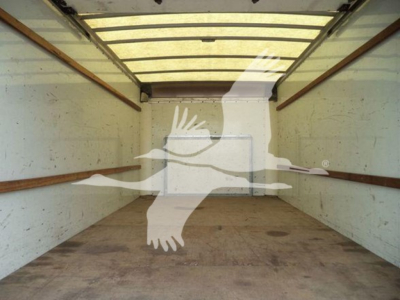 Ford E-350 XL SD truck cargo area showing empty interior with white walls and wooden floor, no visible equipment labels in this image.