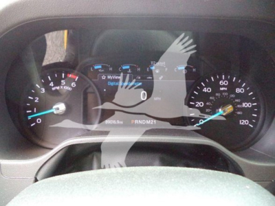 Dashboard view of a 2022 Ford E350 Xl Sd showing instrument cluster with speedometer, tachometer, and digital display; gear indicator PRNDM21 visible.
