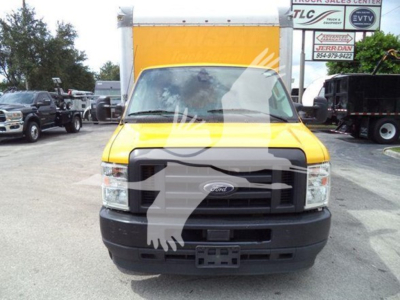 Front view of a yellow Ford E-350 XL SD box truck, with black grille and bumper, displaying a large cargo box in background.