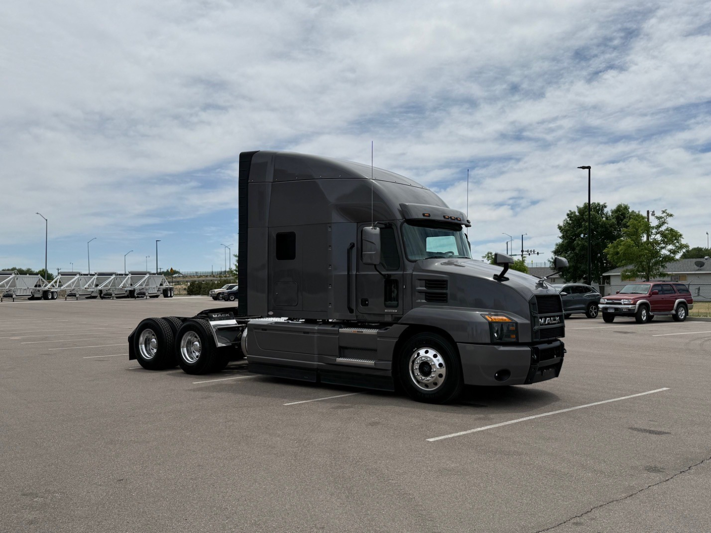 Truck tractor in a parking lot showing the Mack ANTHEM cab and dual rear axles; no visible text legible on side of cab or decals.