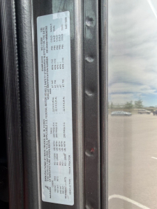 Truck door sticker with detailed specifications and VIN label (MACK ANTHEM). Visible text includes VIN 1M1AN4GY9RM040365 and stock number B3528P along with various weights and engine/axle data.