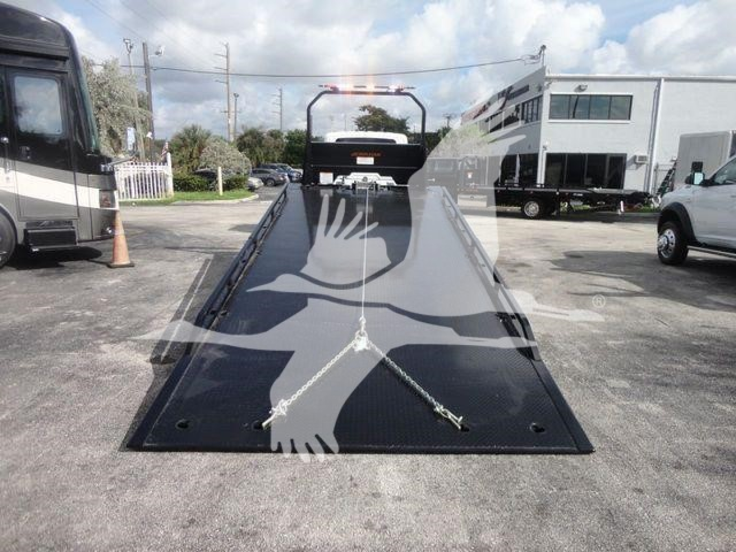 Truck rollback bed on a new 2027 International MV with a front-facing view of the loading ramp and winch bar.