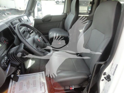 Truck cab interior with two front seats and steering wheel of a 2027 International MV, dashboard visible.