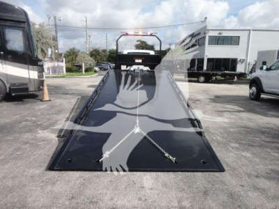 Truck rollback bed on a new 2027 International MV with a front-facing view of the loading ramp and winch bar.