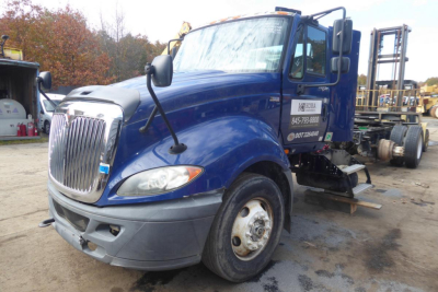 International Prostar+ 122 daycab truck in blue with front grille and side mirrors, VIN sticker and stock number visible on door, used vehicle.