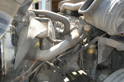 Engine bay of a 2012 International PROSTAR+ Daycab showing various hoses, tubes, and components
