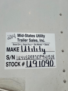 Sticker on side of trailer showing ‘2014 Mid-States Utility Trailer Sales, Inc.’ with Make Utility handwritten, S/N UYVS...941508 and STOCK # U91090.