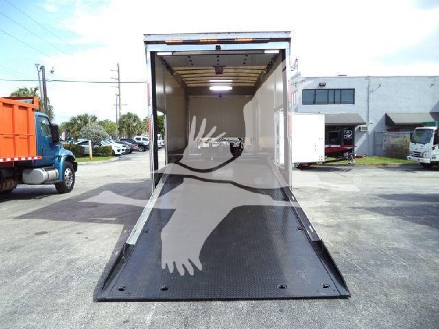Truck cargo area showing open lowered ramp in a 2022 Mack MD6 rollback truck listing