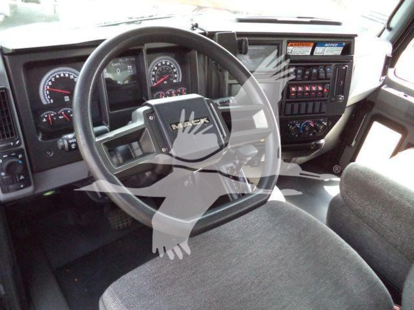 Mack MD6 interior dashboard showing steering wheel and instrument cluster.