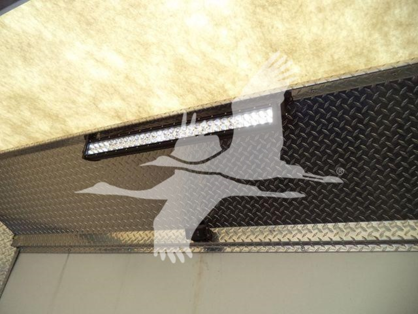 Truck equipment rack with diamond plate surface and LED light bar.