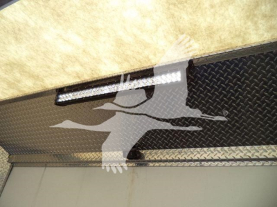 Truck equipment rack with diamond plate surface and LED light bar.