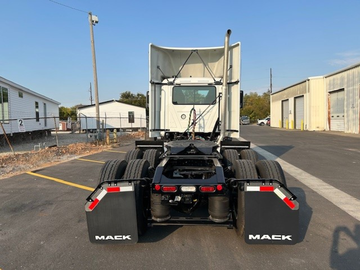 Mack AN64T semi truck rear view showing dual rear axles and Maek mudflaps.