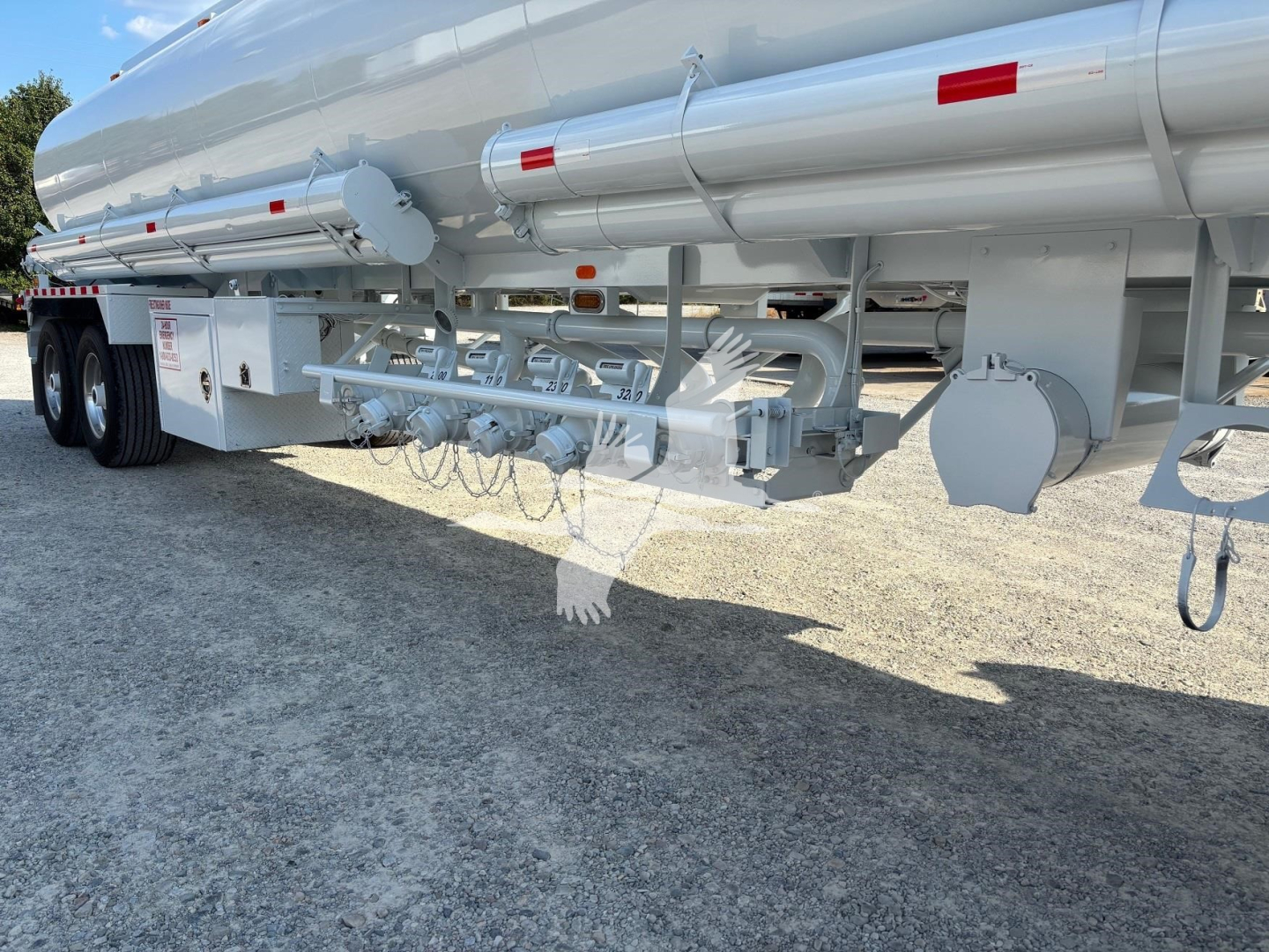 Heil 9200 gallon gasoline trailer undercarriage with piping, valves, and support framework visible.