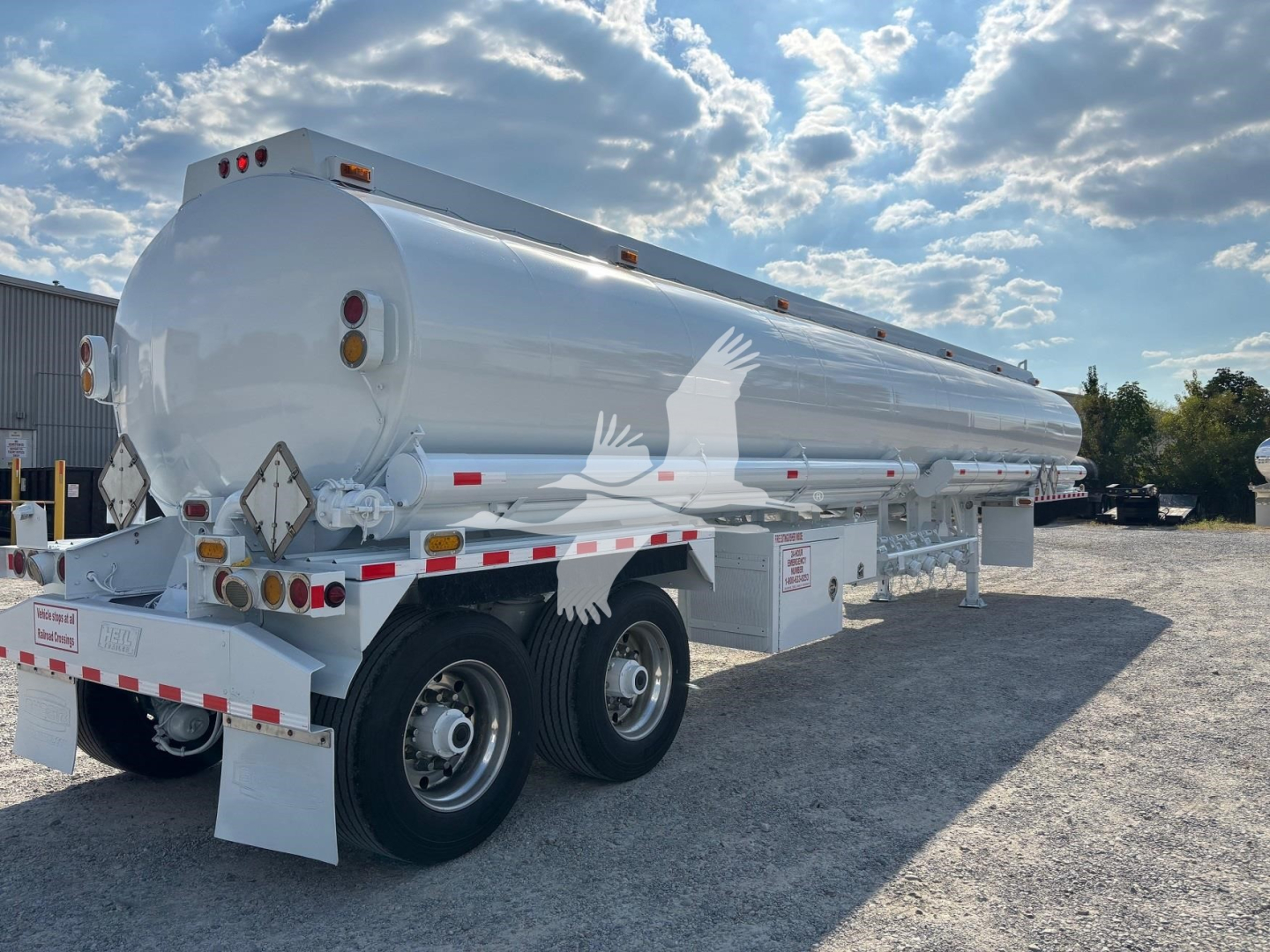 2019 Heil 9200 Gallon tanker trailer showing cylindrical stainless tank on dual-axle chassis with rear and side safety reflectors and signage.