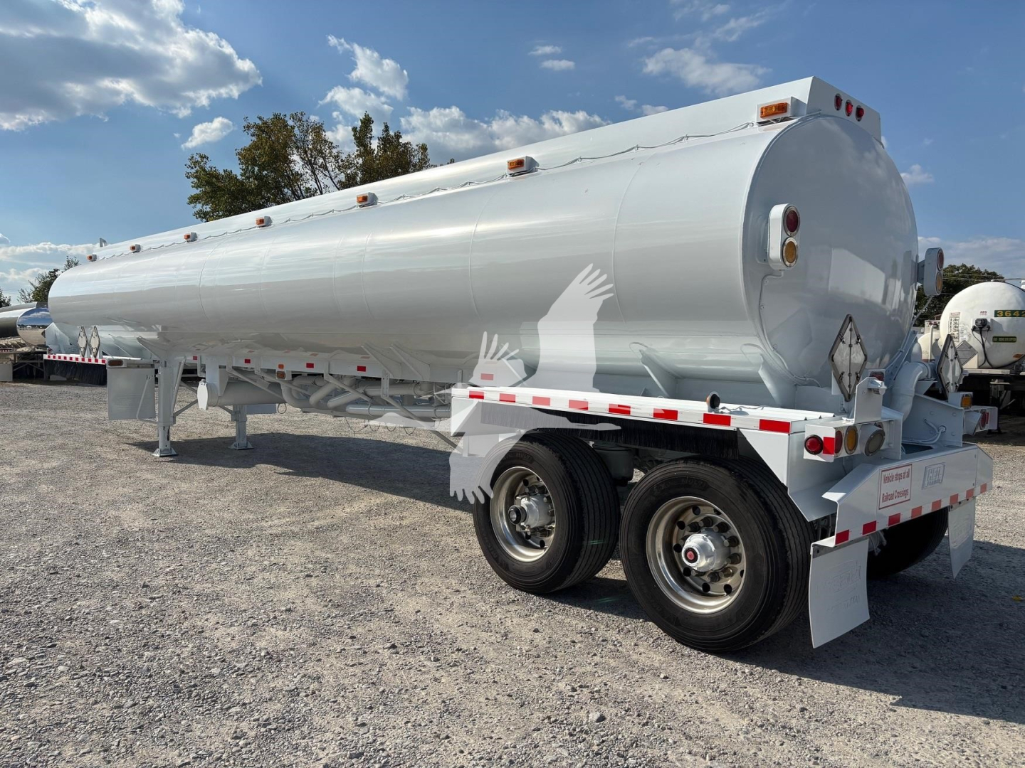 2019 Heil 9200Gal gasoline trailer showing cylindrical tank on dual-axle chassis with white exterior, rear lights, and safety markings.
