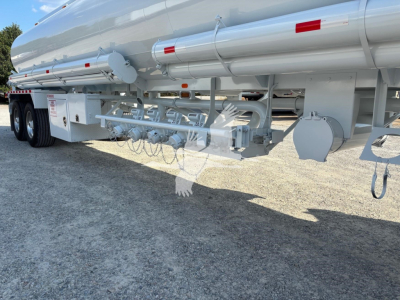 Heil 9200 gallon gasoline trailer undercarriage with piping, valves, and support framework visible.