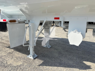 Trailer landing gear and underside of a Heil 9200 gallon tank trailer showing support legs, frame, and plumbing fittings.