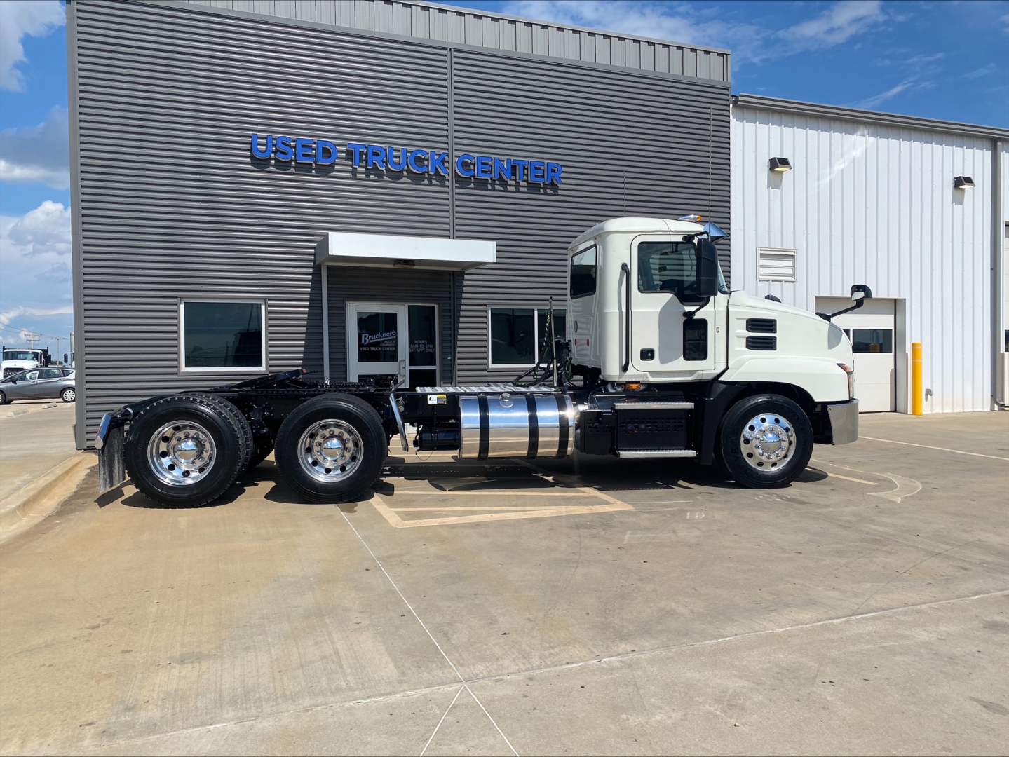 2021 Mack AN64T daycab tractor at a used truck center with VIN 1M1AN2GY4MM022143 and stock B3379P visible.