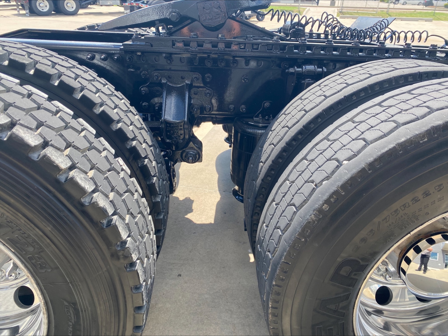 Mack AN64T truck rear axle area showing dual rear tires and suspension components, undercarriage with frame and axle housings visible.