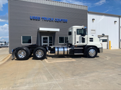 2021 Mack AN64T daycab tractor at a used truck center with VIN 1M1AN2GY4MM022143 and stock B3379P visible.