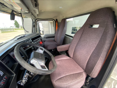 Interior of 2021 Mack AN64T cab showing steering wheel and seats.