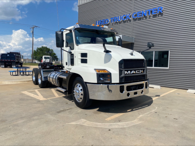 Mack AN64T conventional daycab truck in white, front three-quarter view, parked outside used truck center.
