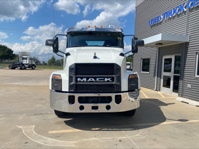 Mack AN64T conventional daycab front view showing grille with MACK emblem and bumper, daytime running lights, side mirrors.
