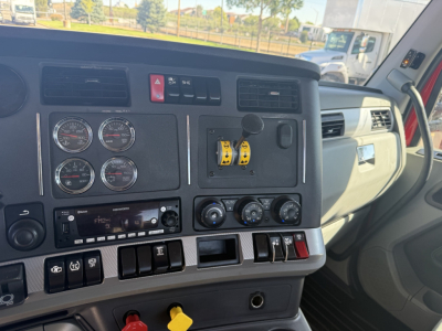 Kenworth T880 truck interior dash showing gauges, switches, and controls in driver’s cabin.
