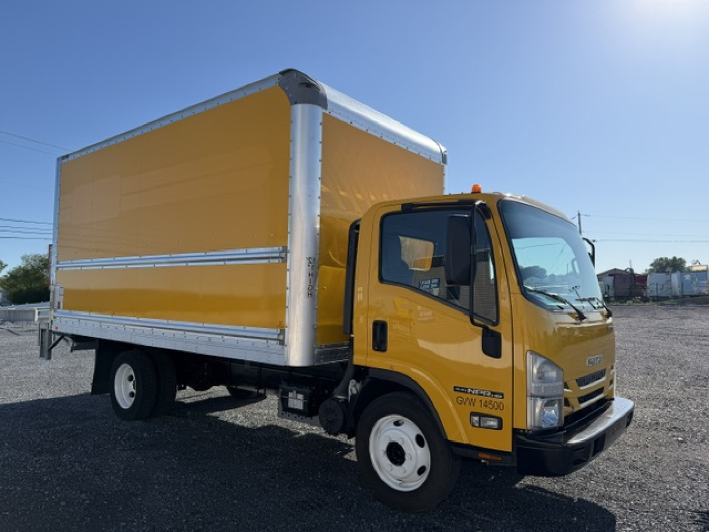 Isuzu NPR box truck in yellow cab and cargo box showing VIN 54DC4W1DXMS201514 and stock number 12902.