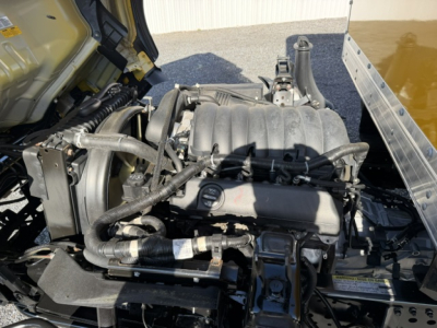 Isuzu NPR engine bay showing air intake and manifold with hoses and components visible.