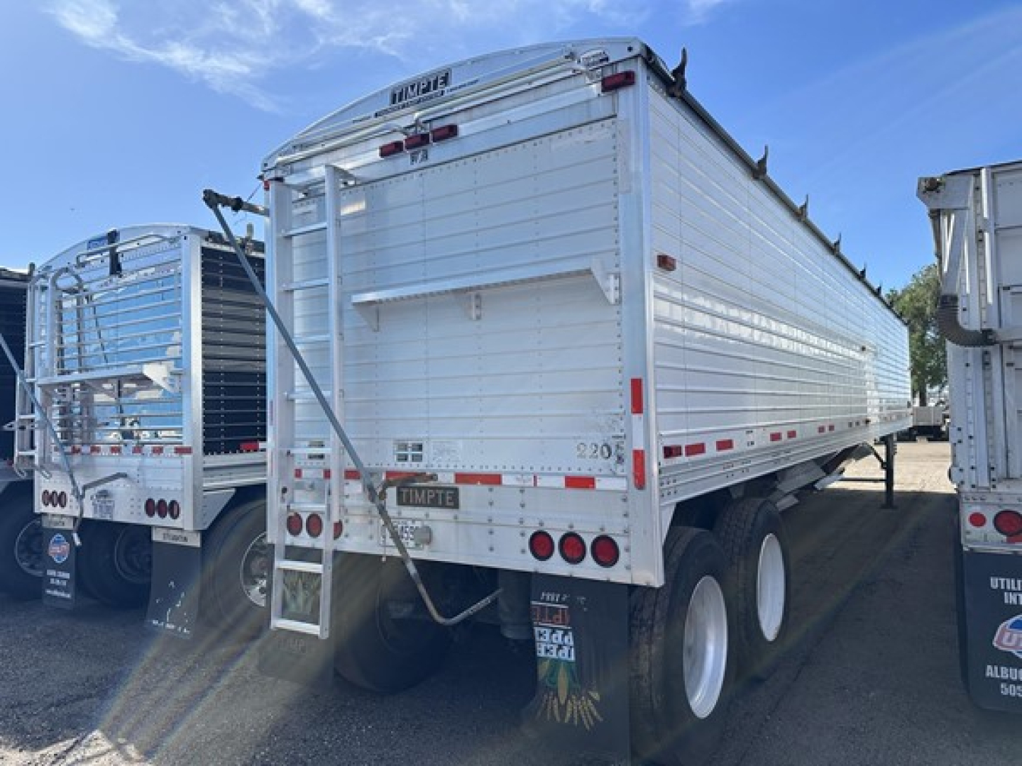 Timpte Super Hopper trailer rear/side view showing dual rear doors, ladder, rear lights, and twin-axle wheels.
