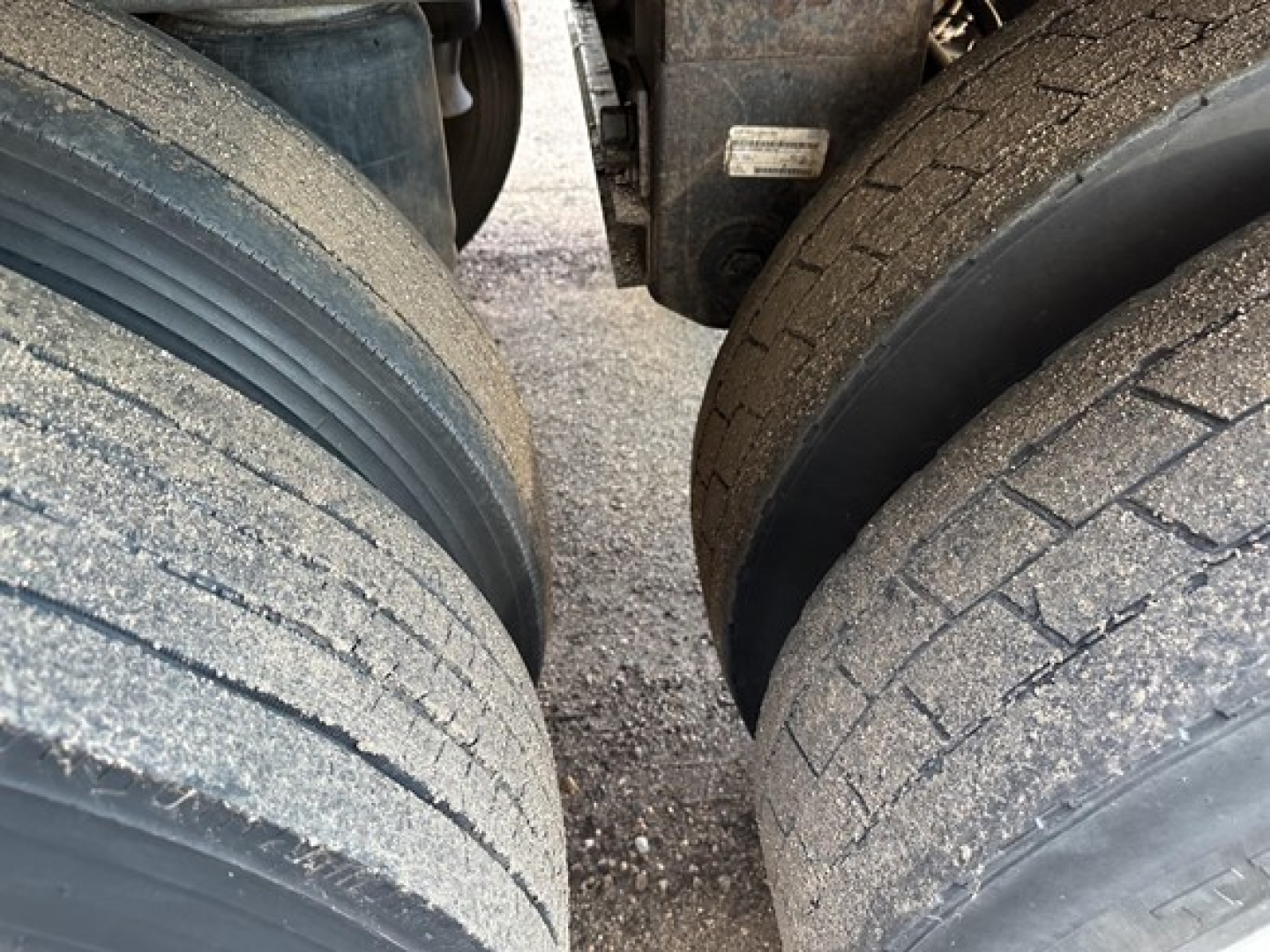 Timpte Super Hopper trailer wheels/axles close-up showing dual rear tires with dirt and wear, part of a used trailer.