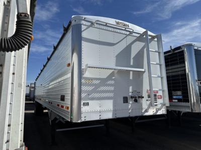  Trailer showing a white Timpte Super Hopper grain trailer with rear ladders and hoppers. Visible side panels and rear doors with small decals.