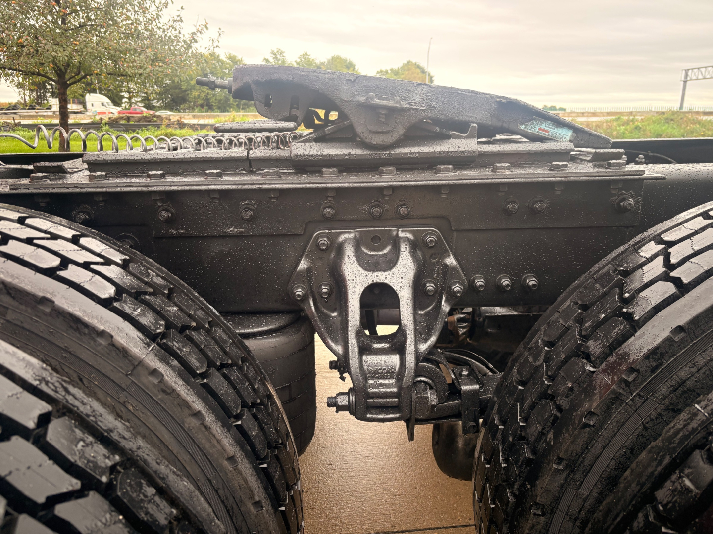 Kenworth T680 chassis framing showing rear suspension and fifth wheel mounting point with dual rear wheels.