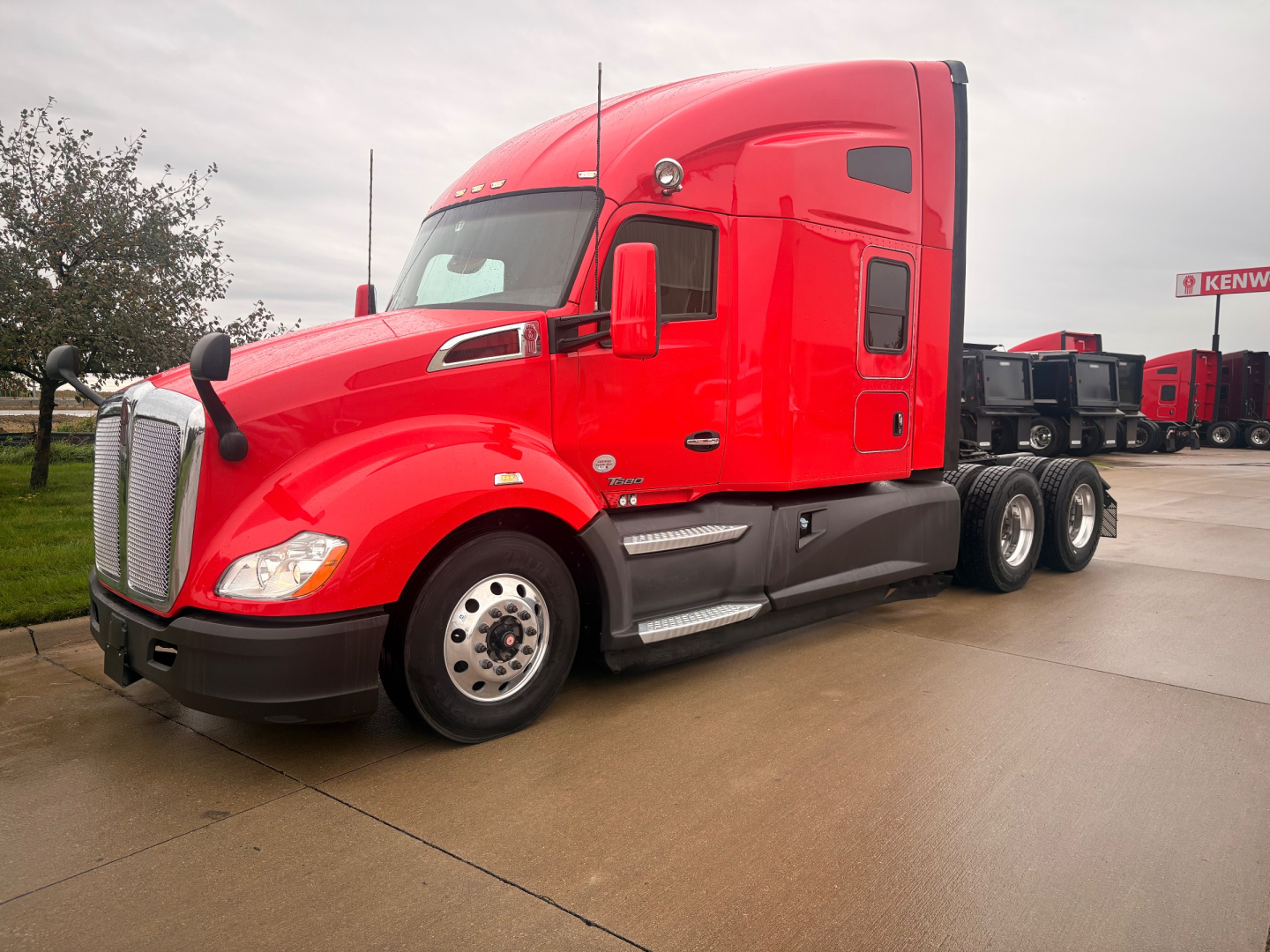 Kenworth T680 tractor in red, side view showing cab and twin rear axles, stock number 0632842, VIN 1XKYD49X1NJ484085
