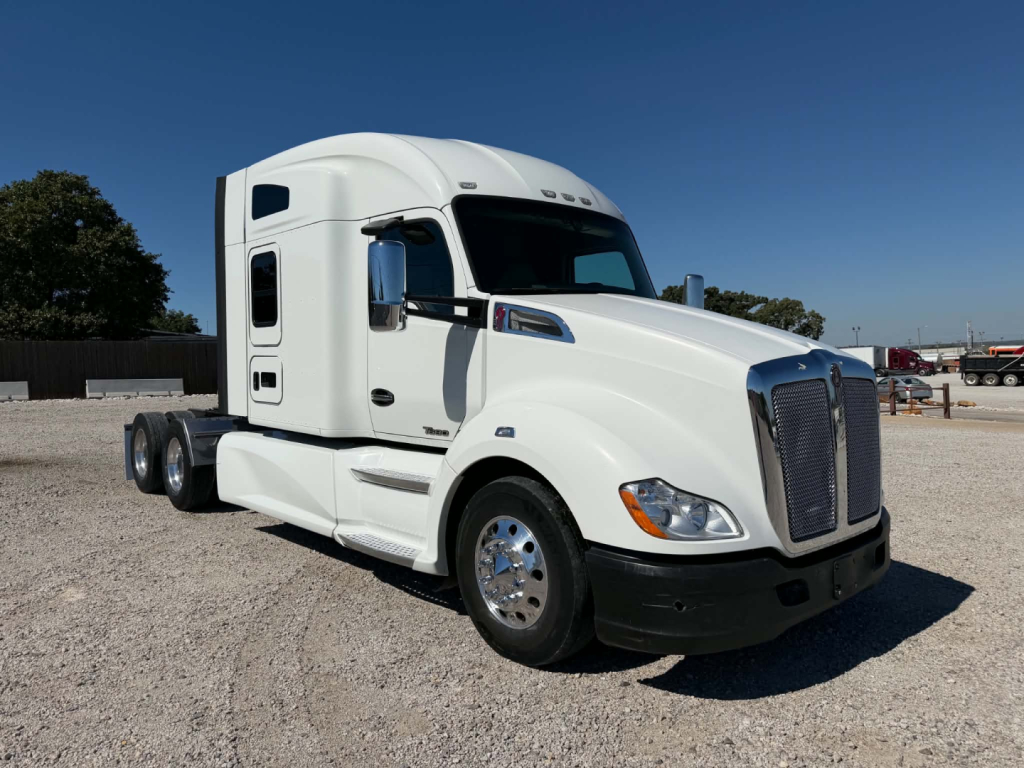 Kenworth T680 truck in white exterior from front-side view with sleeper cab.