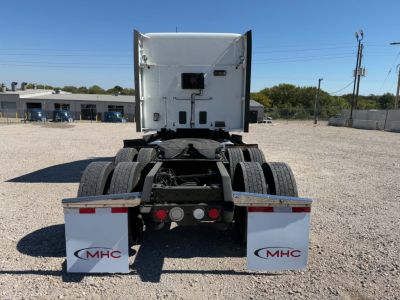 Rear view of a Kenworth tractor with fifth wheel, dual rear axles, and MHC mud flaps showing MHC logos.