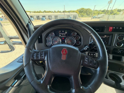 Kenworth T680 steering wheel and dashboard view with instrument cluster and control stalks visible.