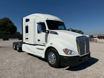 Kenworth T680 truck in white exterior from front-side view with sleeper cab.