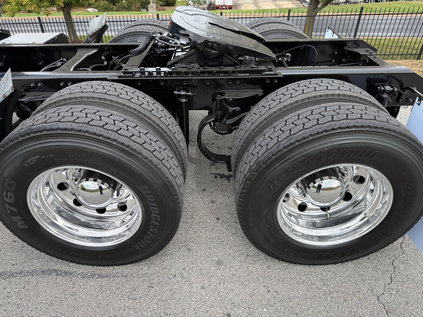 Kenworth T680 chassis showing dual rear axles and chrome wheels with tires.