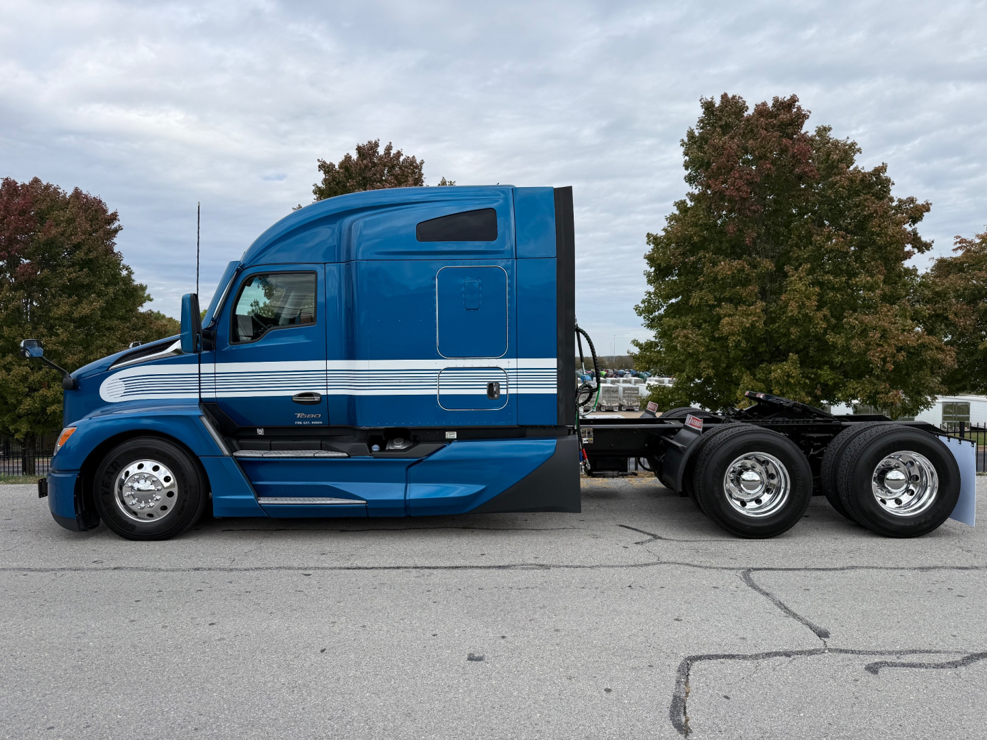 Kenworth T680 sleeper cab aerial view showing blue exterior with white striping and rear chassis wheels.
