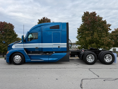 Kenworth T680 sleeper cab aerial view showing blue exterior with white striping and rear chassis wheels.