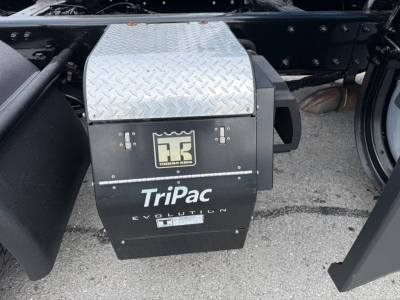 Kenworth T680 undercarriage showing TriPac Evolution auxiliary power unit with Diamond plate cover and Thermo King logo.