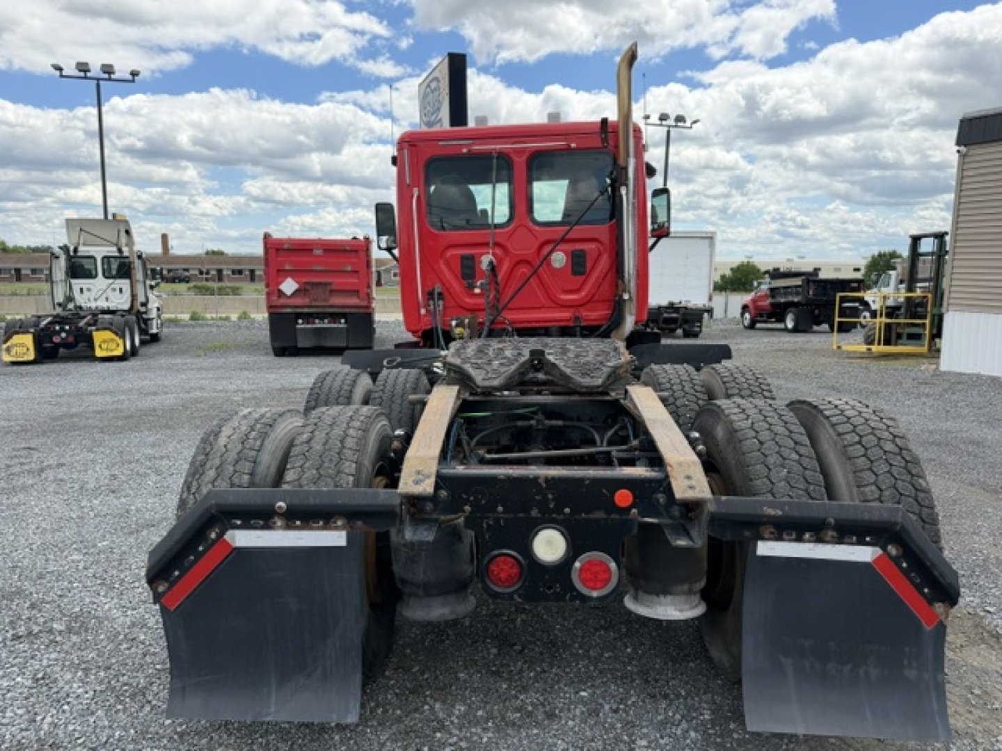 Freightliner Cascadia CA125DC tractor rear view showing chassis and dual rear wheels with mud flaps.