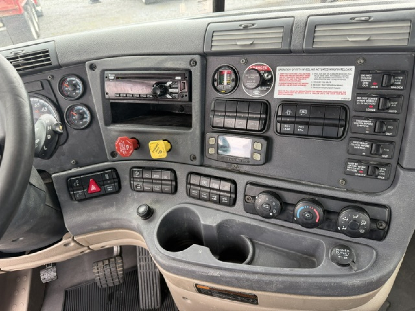 Cascadia dashboard showing control switches and gauges in cab interior.
