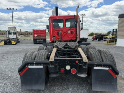Freightliner Cascadia CA125DC tractor rear view showing chassis and dual rear wheels with mud flaps.