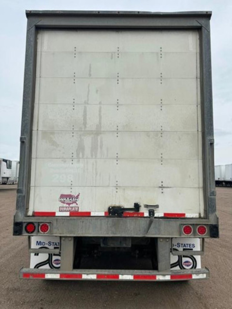 Rear view of a 2016 Wabash box trailer showing back doors and reflective tape. Visible text includes N/A on license areas and small labels at bottom right and left reading 'MId-STATE' and 'STATES'.